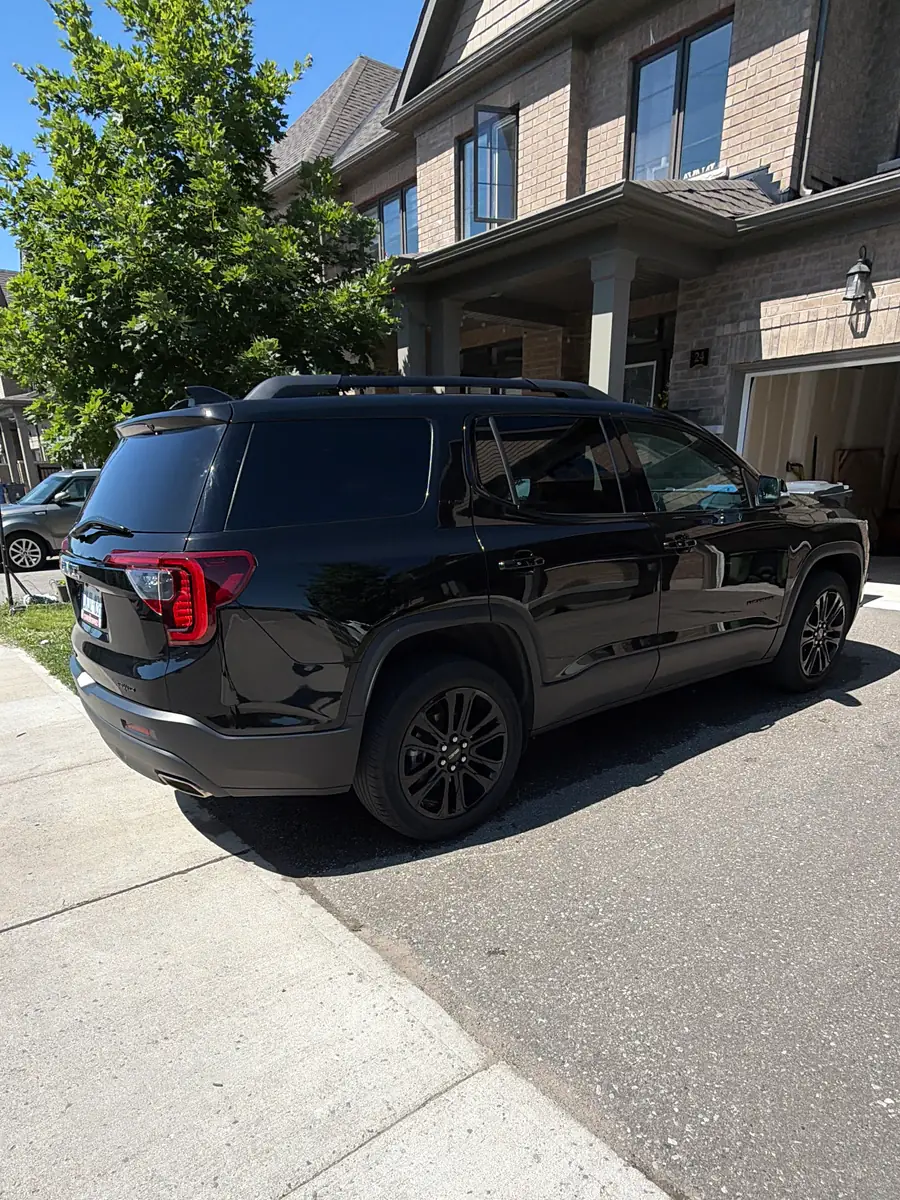 Black GMC SUV parked in a Guelph driveway, paint and wheels clean after a mobile detail